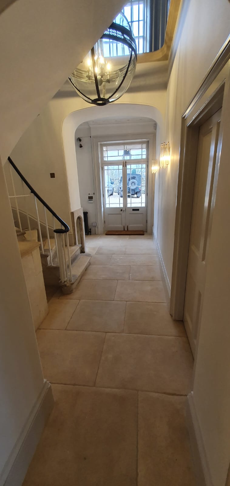 Stone-coloured floor tiles running through a hallway