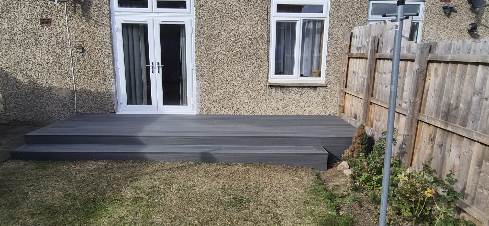 Composite decking laid against the house