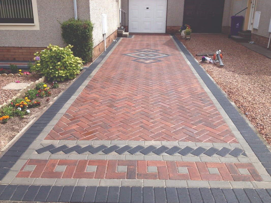 Herringbone block driveway finished with a geometric border