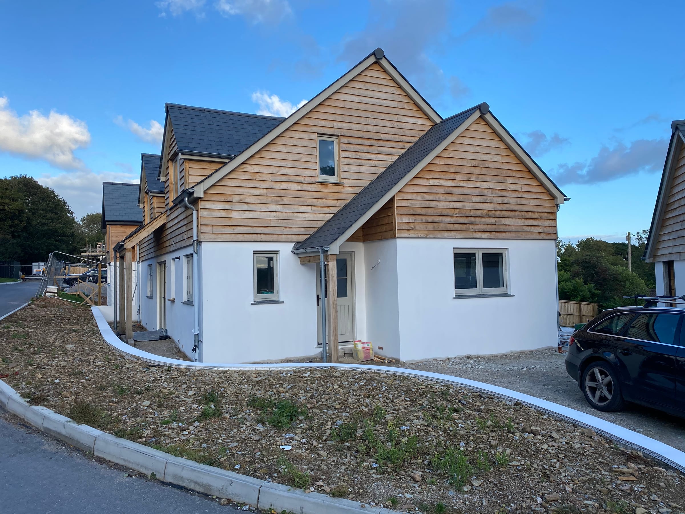 New-build home in render and timber by Mitchell & Andrew Building Services