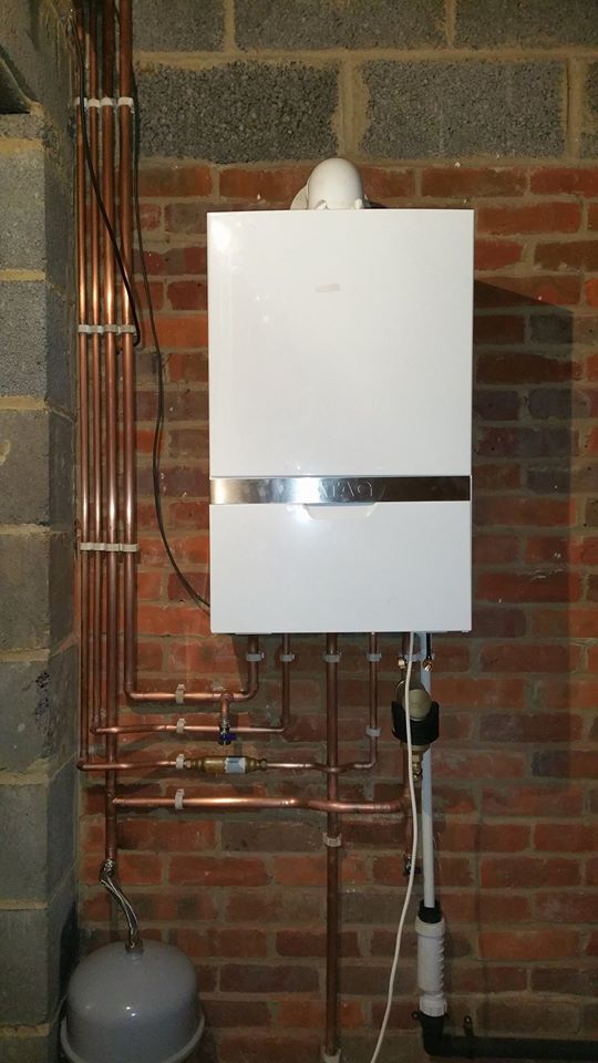 Engineer from Home Comfort Assured checking a heating system