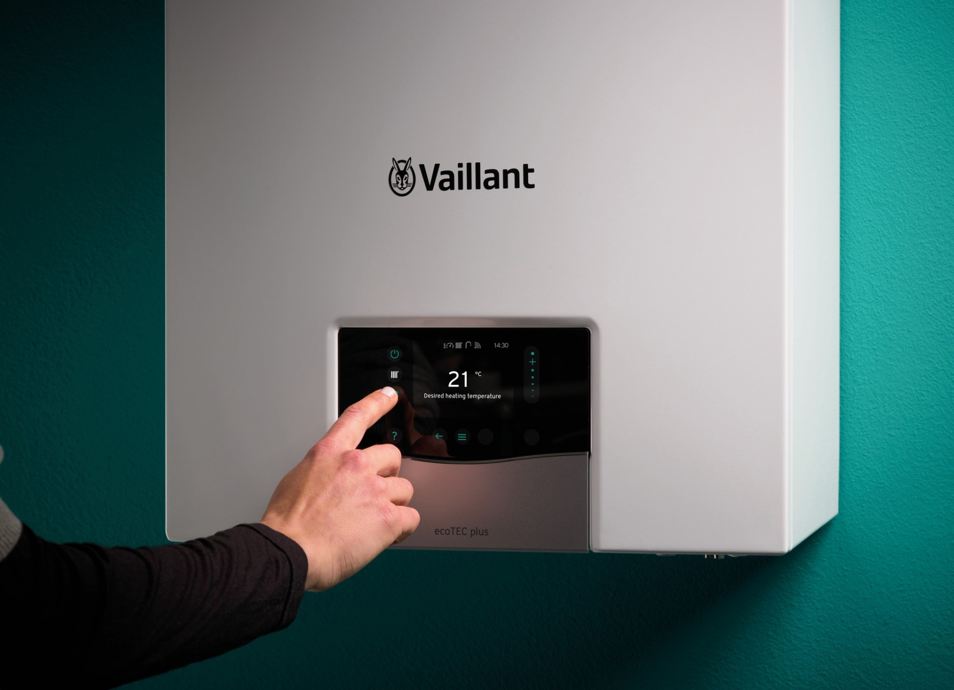 Vaillant boiler installed by our team, with a hand adjusting its controls