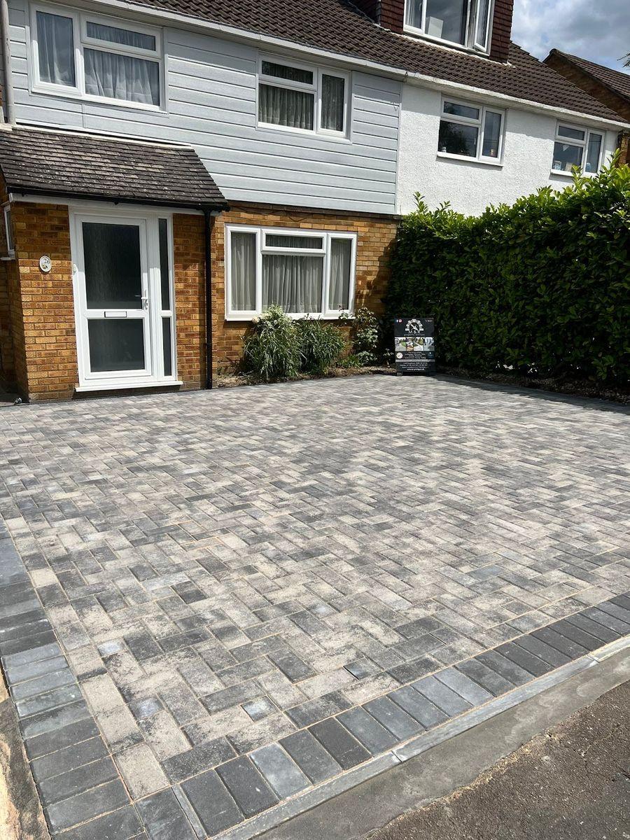 Grey block paving driveway on a semi-detached house