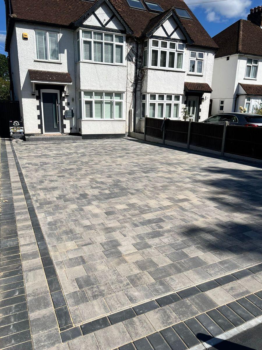 Finished grey block paving driveway with a dark border