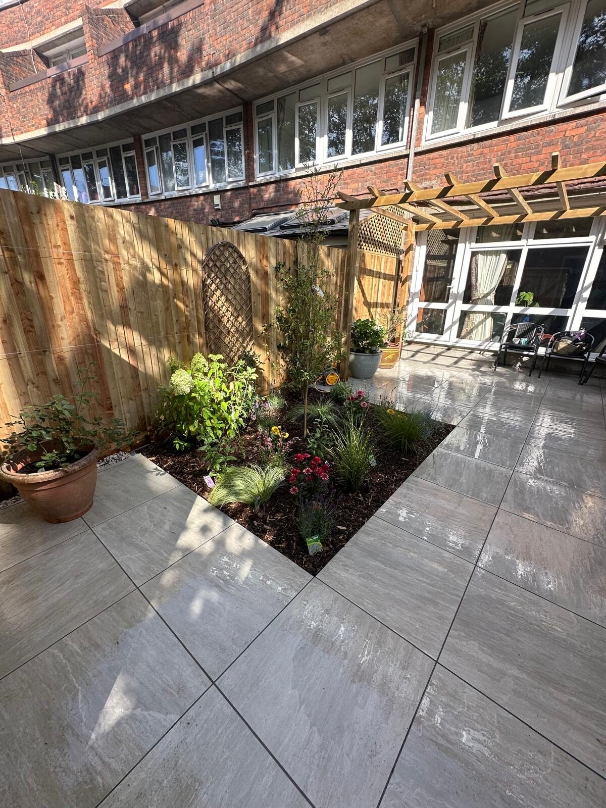 Completed courtyard garden with new paving and an angled finish at the rear