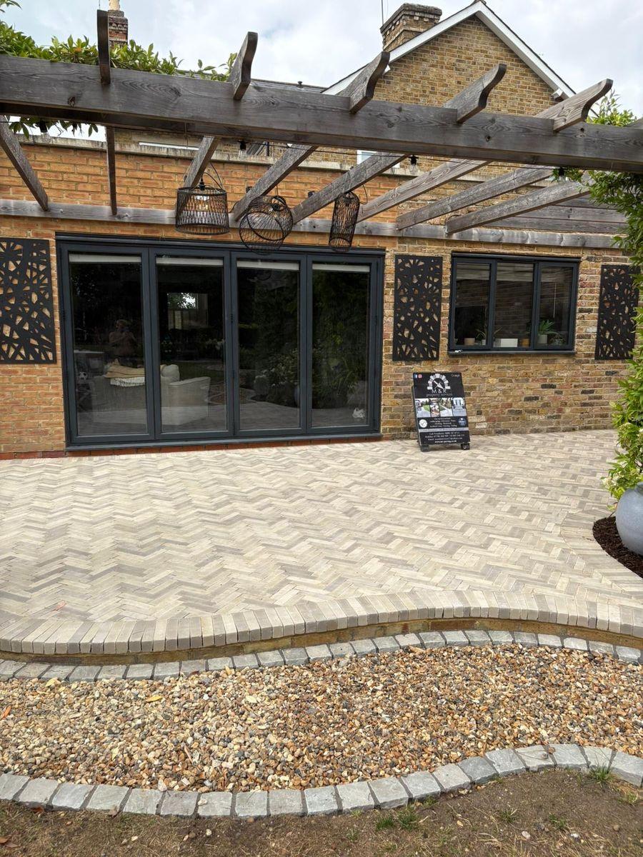 Herringbone block paving patio with a gravel border